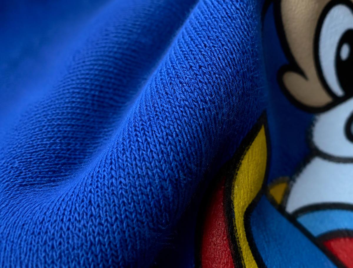 Macro close-up of the combed cotton knit and printed artwork edge